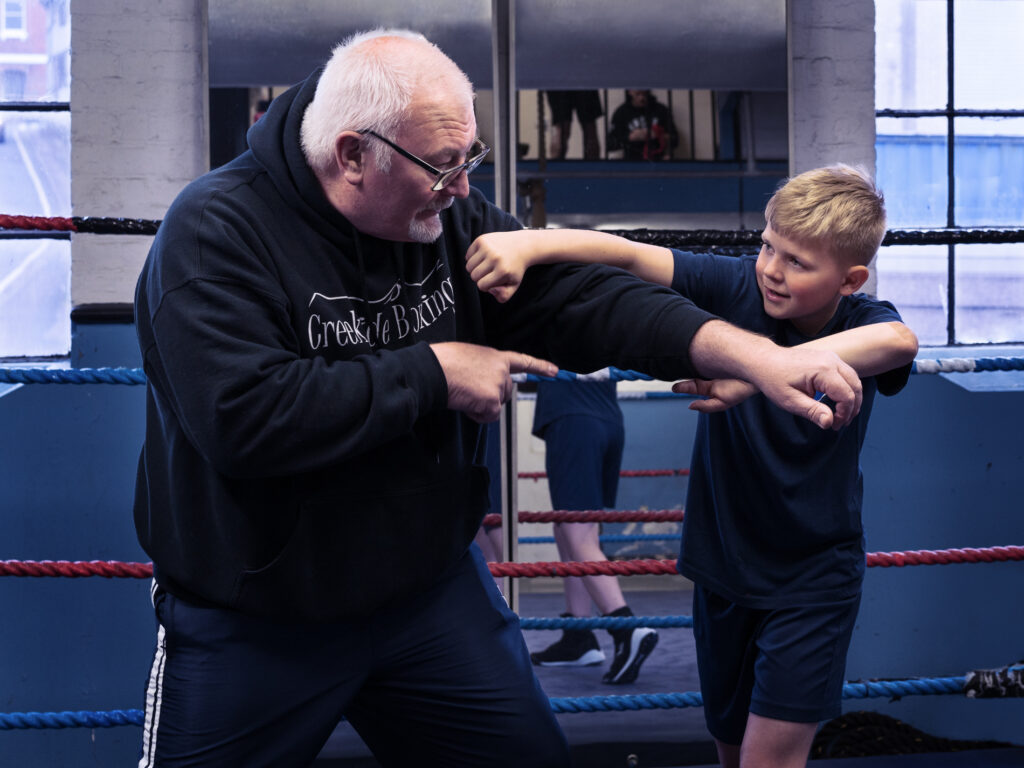 boxing-coach-training-child