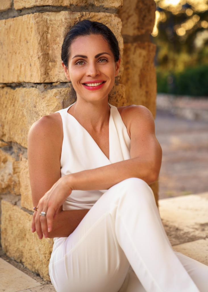 Photograph of Daria dressed in white in the evening sun in Spain