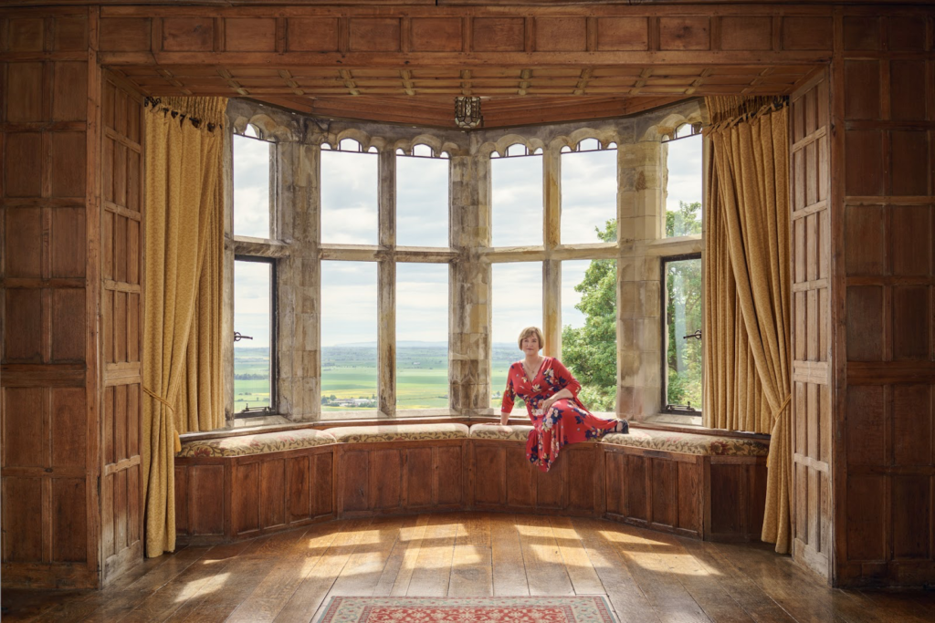 Photograph of Karina sat in the window seat at Lympne Castle