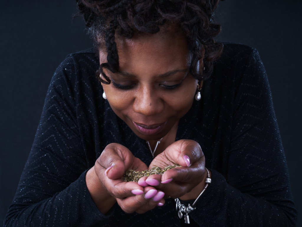 Photograph of Veronica holding out tea leaves