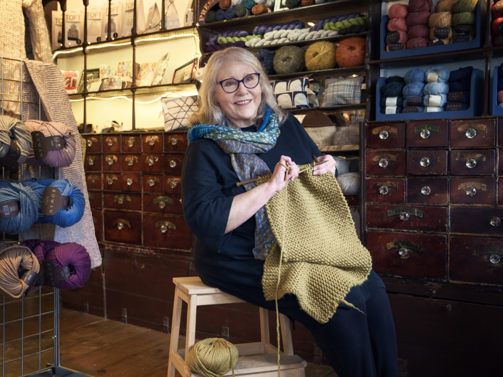 Photograph of Vanessa knitting in the Yarn Dispensary, Faversham, Kent